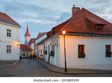 Cobbled street in the historical downtown on a winter evening. View of the St. Nicholas Church. Znojmo, Czech Republic, South Moravia, Europe