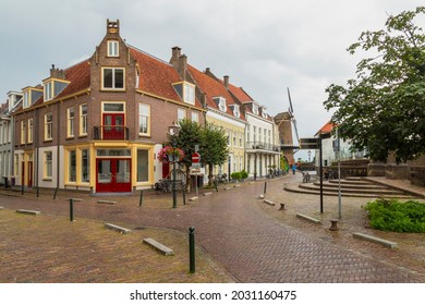 Cobbled streets with monumental houses and a view of the mill in the center of the medieval town of Wijk bij Duurstede, Netherlands.