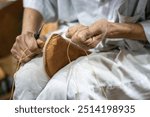 cobbler hands sewing hand made shoes in the souk market in the medina in Marrakesh, Morocco