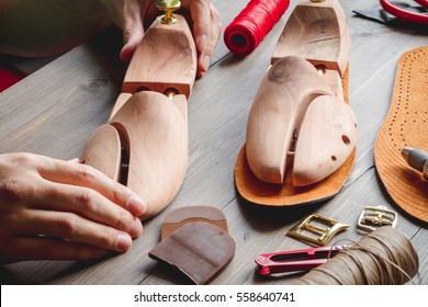cobbler tools in workshop dark background close up