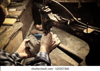 cobbler at work with sewing machine - Powered by Shutterstock