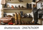 Cobblers shop (shoe and boot repairers) displaying a selection of  footware from various era