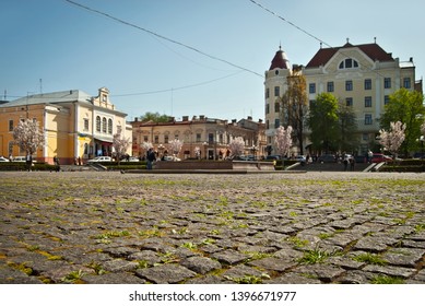 Cobblestone close-up. Sharpness on granite tile. Square and street are blurred in the background. Layout for design. The area is removed from the lower angle.