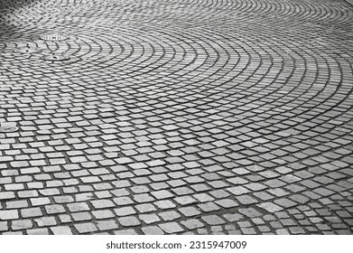 Cobblestone pattern on the road. Cobblestone texture on the street, close up. Brick floor tiles.