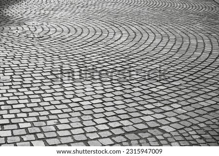 Cobblestone pattern on the road. Cobblestone texture on the street, close up. Brick floor tiles.