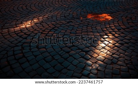 Cobblestone pavement Stone road in the street of old town. Sunlight on cobblestone road in the morning. Old stone texture