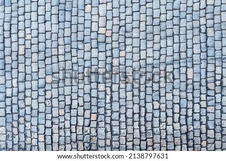 Cobblestone pavement texture background. Top view of stone road. Detail of granite sidewalk taken from above. Old street cobblestones for backdrop. Abstract vintage pavement with rough blocks. Foto stock © 