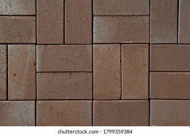 Cobblestone texture. The sidewalk tile is evenly folded. Brown cobblestones close up.