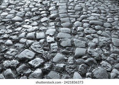 Cobblestone tiles street with big stones, top view. Ancient stone floor. Old pavement for a poster, calendar, post, screensaver, wallpaper, postcard, cover, web. Toned high quality photography