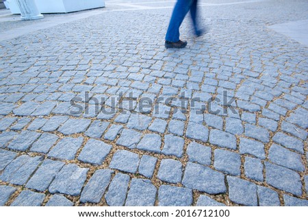 Cobblestone and a walking woman