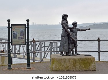 Cobh, Ireland, April 12, 2018 -- The Annie Moore Statue Stands Outside The Cobh Heritage Centre. It Commemorates The First Immigrant To The United States To Pass Through The Facility At  Ellis Island.