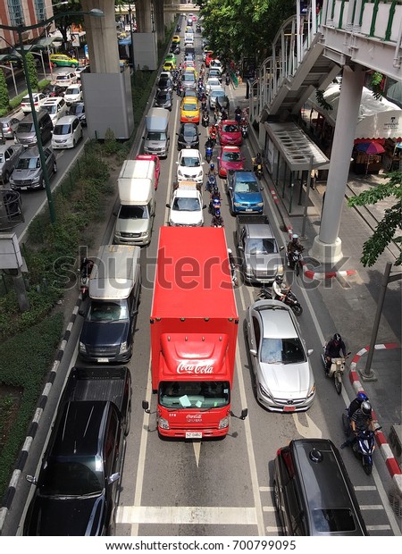 Coca Cola\' red truck for delivery\
in downtown of Bangkok stuck in traffic road, Thailand. Photo taken\
in August 2017. Logistics and transportation\
concept.