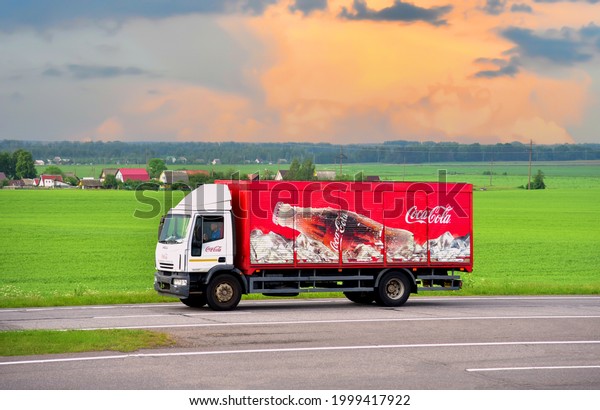 Coca Cola Truck with  driving along highway. Goods\
Delivery by roads. Services and Transport logistics. Russia, Moscow\
region, JUN 28, 2021