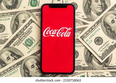 Coca-cola stock market price. Logo close-up view and dollar money background. Business and finance concept