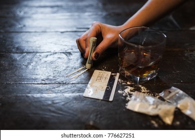 Cocaine and alcohol drink on dark background. Detrimental lifestyle. Bad habits. Alcohol and drug addiction. Important problem of modern society