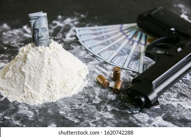 Cocaine with dollar notes on the table. Drugs addict dealer.  Dangerous gun. Unhealthy life concept.