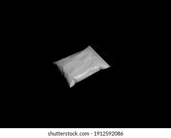 Cocaine Drug Powder In Bag On Black Background