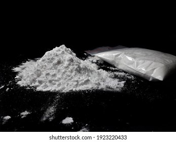 Cocaine Drug Powder Pile And Bag On Black Background