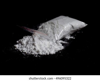 Cocaine Drug Powder Pile And Bag On Black Background