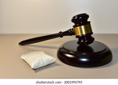 Cocaine And Judge Hammer In Courtroom. Legal Excuse And Justice Concept. Sentence To A Criminal For Committing A Drug Offense. Drug Laws. Judgment A Life Sentence In Prison. Mallet Of Federal Judge 
