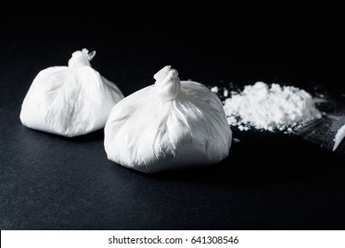 Cocaine Poured And Cocaine In A Bag On A Black Background