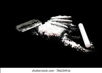 
Cocaine and Razor blade on a black background