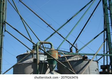 Cocecha Grain Silos With Their Crossed Pipes Form A Graphic Design Illustrated With A Blue Sky Background.