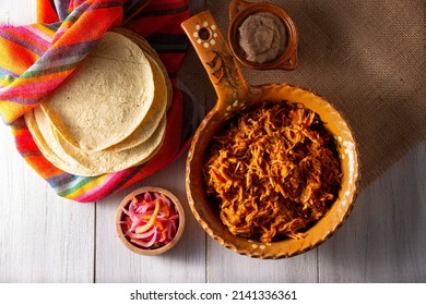 Cochinita Pibil. Typical Mexican stew from Merida, Yucatan, made from pork marinated with achiote and generally accompanied with beans and red onion with habanero chili, it can be eaten in tacos.