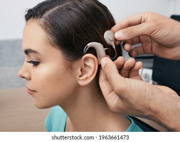 Cochlear Implant. Installation Cochlear Implant On Woman's Ear For Restores Hearing