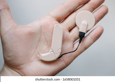 Cochlear Implant On The Arm. Hearing Aid