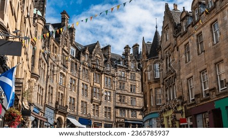 Cockburn shopping street with colorful shops and old stone buildings in Edinburgh, Scotland.