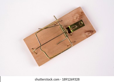 Cocked wooden Mousetrap without a bait, viewed in close-up isolated on white background.Large wooden mousetrap.High resolution photo.