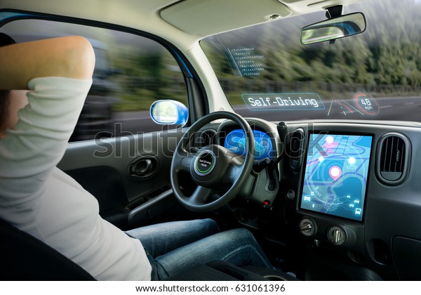 cockpit of autonomous car. a\
vehicle running self driving mode and a woman driver being\
relaxed.