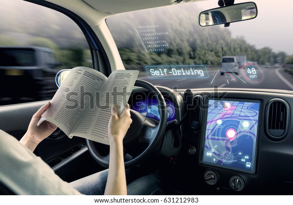 cockpit of autonomous car. a\
vehicle running self driving mode and a woman driver being\
relaxed.