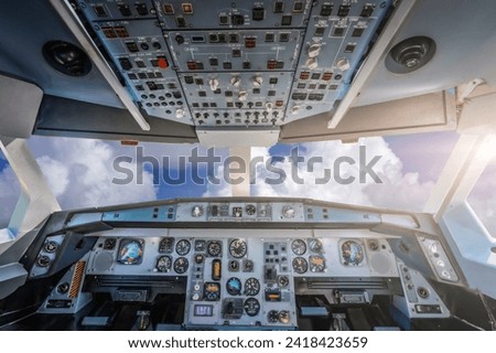 Cockpit with control panel against cloudy sky