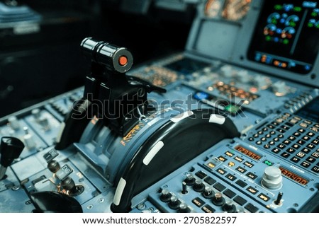 The cockpit control panel features numerous buttons, switches, and a throttle lever as a pilot prepares for takeoff in a flight simulator. The lighting adds to the realistic environment.