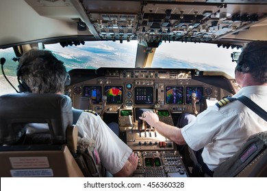 Cockpit (Flight Deck) Of Modern Wide-body Airplane In Flight. Aircraft Pilot At Work.