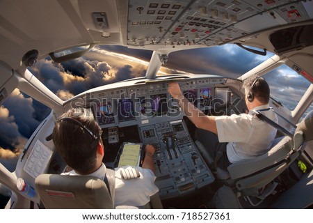Cockpit of a modern passenger aircraft. The pilots at work.