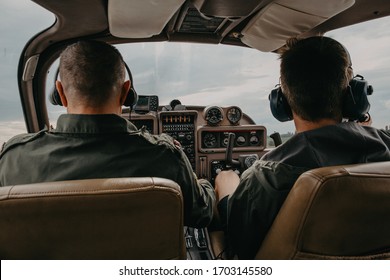 The Cockpit Of The Pilot. Pilots Are Cooperating During A Flight On A Small Aircraft. Pilot In Cockpit With Blur Pilot