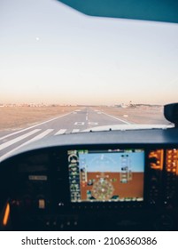 Cockpit Of A Small Plane Landing On The Airport Runway At Sunset