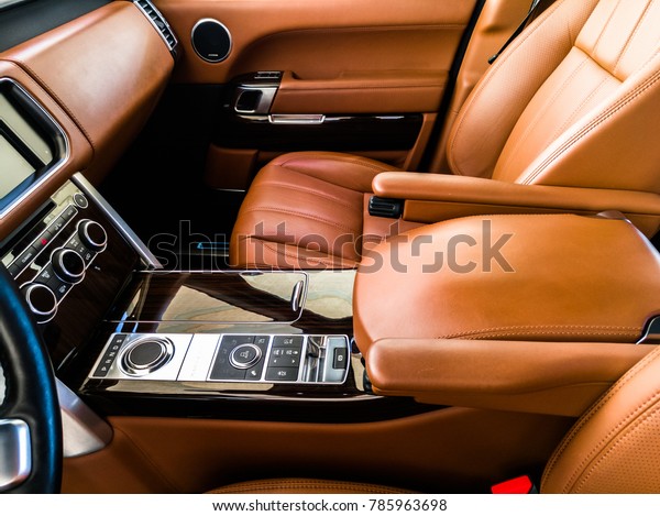 cockpit view of an exotic luxury vehicle and the\
leather is in brownish color\
