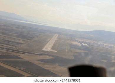 Cockpit view of the plane landing on the runway at a small airport. - Powered by Shutterstock