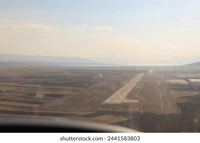 Cockpit view of the plane landing on the runway at a small airport. - Powered by Shutterstock