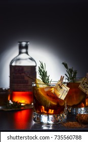 cocktail with apple juice, rum, cinnamon, pear and rosemary
