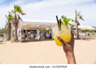 cocktail with beach in background - Shutterstock ID 2172079929