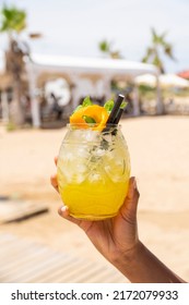 cocktail with beach in background - Shutterstock ID 2172079933