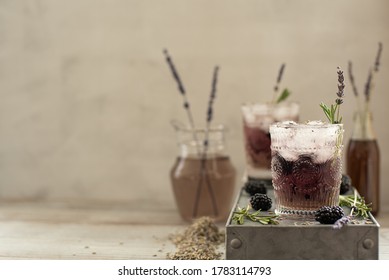 cocktail with berries and lavender syrup on a light background - Powered by Shutterstock