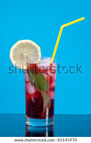 cocktail  with cherry closeup isolated on blue background.