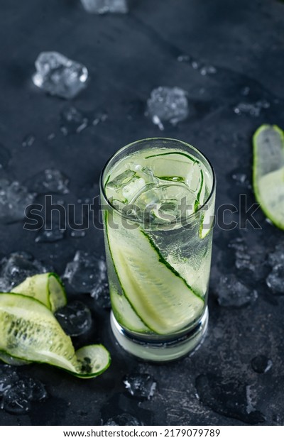 cocktail with cucumber and ice. Infused cucumber\
drink with mint. Detox water. Darck background. Gin Gimlet Cocktail\
with Cucumber Slice