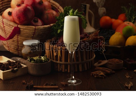 cocktail dekorate parsley on a wooden background. Background decorated with fruits and herbs.
